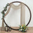 Decorative floral arch with draped fabric and lanterns for events or photography.