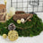 Decorative natural elements with moss, pinecones, and woven orbs on a table.