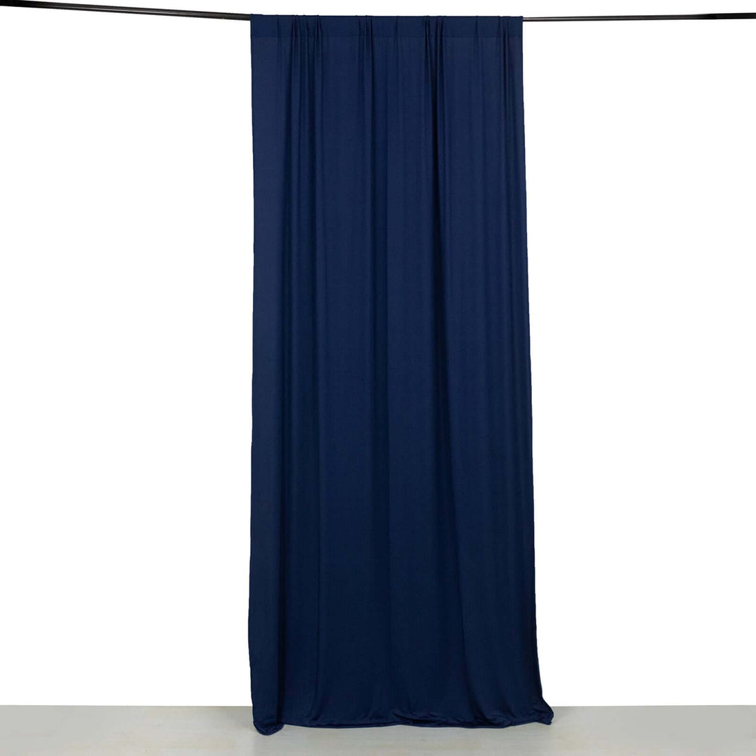 Navy fabric curtain hanging from a rod