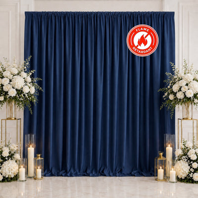 Navy blue curtain backdrop with white floral wedding decor and candles
