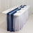 Table set for a formal event with navy blue table runner and glassware.