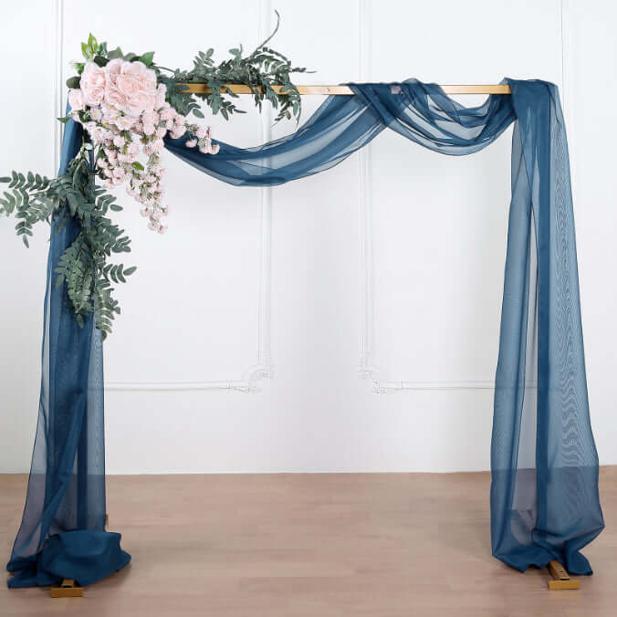 Decorative arch with navy drapes and floral accents for events
