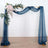 Decorative arch with navy drapes and floral accents for events