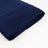 Navy blue folded fabric on a plain backdrop