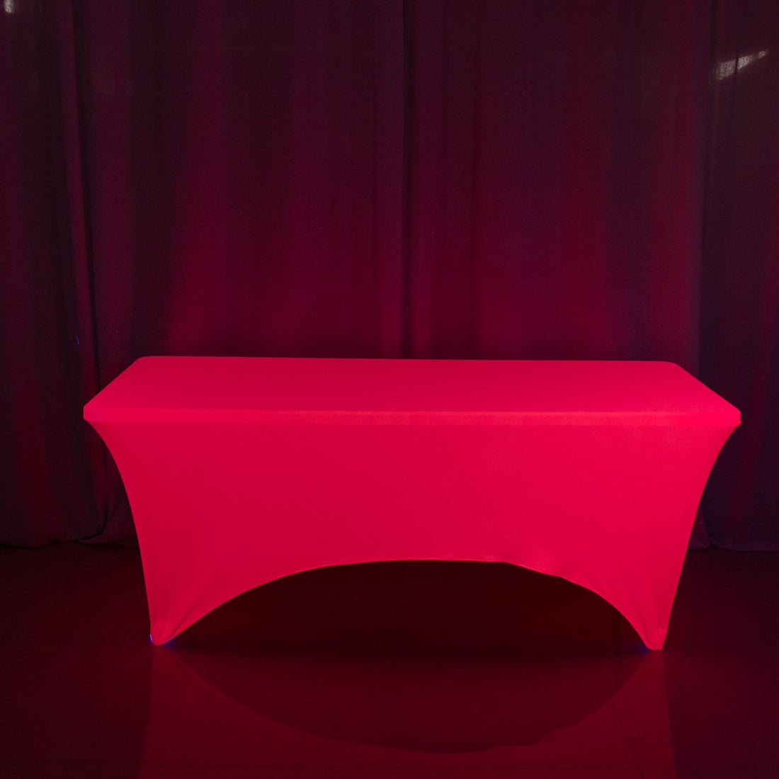 Red table cover on a plain surface with dark backdrop.