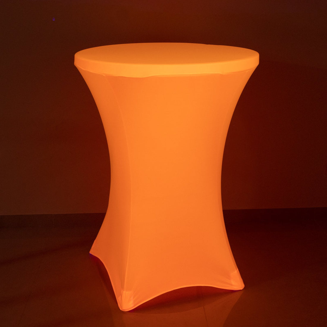 Illuminated orange cocktail table with a sleek design.