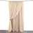 Beige curtain hanging on a rod, elegantly draped with a tieback.