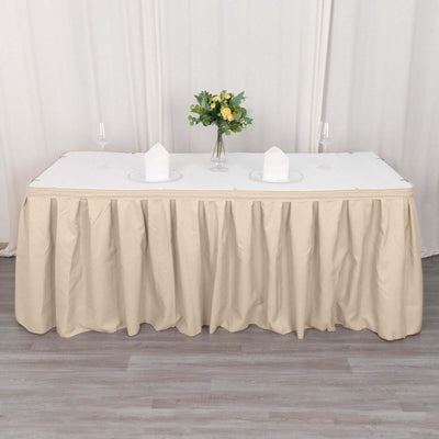 Beige tablecloth draped over a rectangular table with floral centerpiece