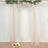 Elegant draped fabric arch with floral accents for events or photography