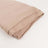 Folded beige fabric on a plain background