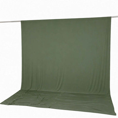 Olive green fabric backdrop on seamless studio background with floor drape