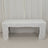 White table covered with a tablecloth in a studio setting.