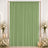 Pastel green event backdrop curtain with floral and candle decor