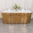 Gold sequin table skirt with floral centerpiece and glassware on a table.