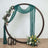 Decorative floral arch with draped fabric and lanterns, set on a wooden floor.