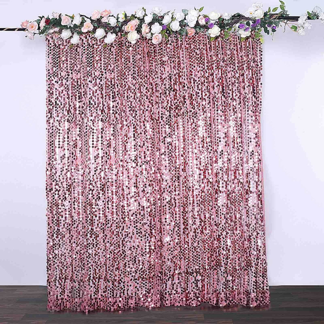 Pink sequin curtain with floral top, perfect for events and decoration.