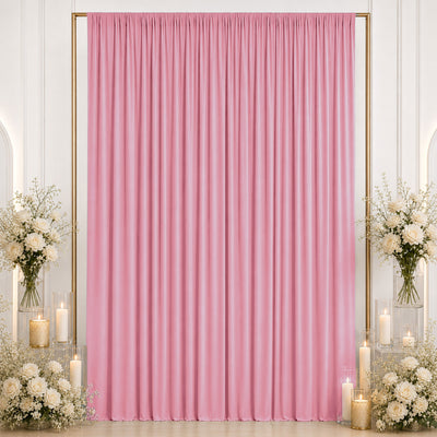 Pink draped backdrop with white roses and candles for elegant wedding decor