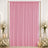 Pink draped backdrop with white roses and candles for elegant wedding decor