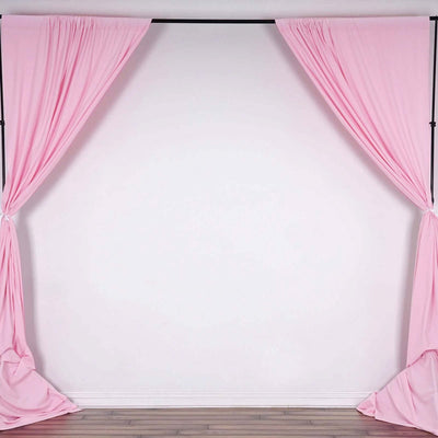 Pink backdrop curtains draped elegantly on a black frame.