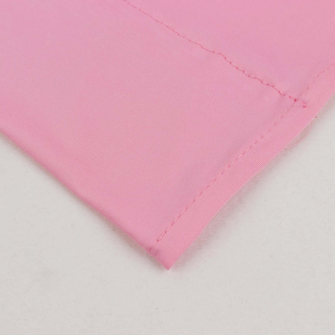 Close-up of pink fabric showcasing smooth texture and seam detail.