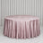 Pink velvet round tablecloth on a table with white curtains backdrop