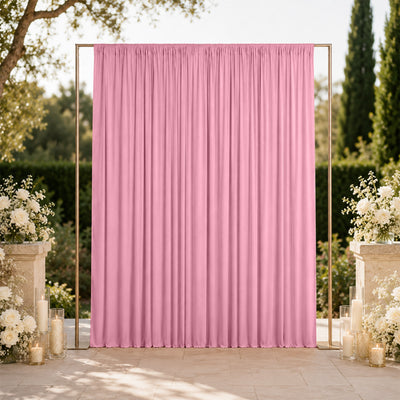 Pink wedding backdrop curtain with floral decor and candles outdoors