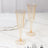 Elegant champagne flutes with gold rim on a marble table