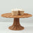 Woven cake stand with two decorative cupcakes on top.