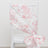 Pink floral chair sash draped elegantly on a white chair.