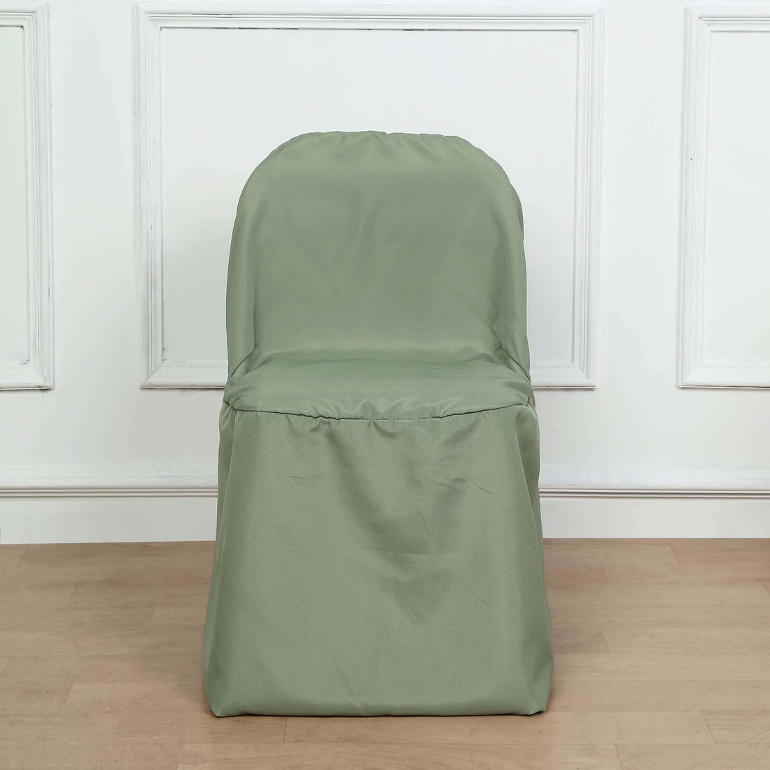 Green chair cover on a plain chair against a light background
