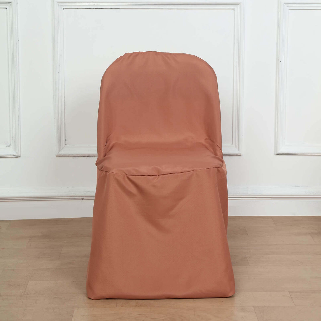 Brown chair cover on a plain chair against a light background.