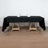 Black tablecloth draped over a wooden table with glasses and napkins