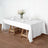 White tablecloth draped over a wooden table set with glassware and floral centerpiece.