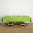 Green tablecloth draped over a wooden table with glassware and napkins.
