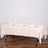 Beige tablecloth draped over a table set for dining.