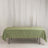 Green tablecloth with gold leaf design on a table.