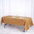Elegant gold tablecloth on a dining table set for two.