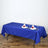 Blue tablecloth draped on a table set for dinner with plates and glasses.