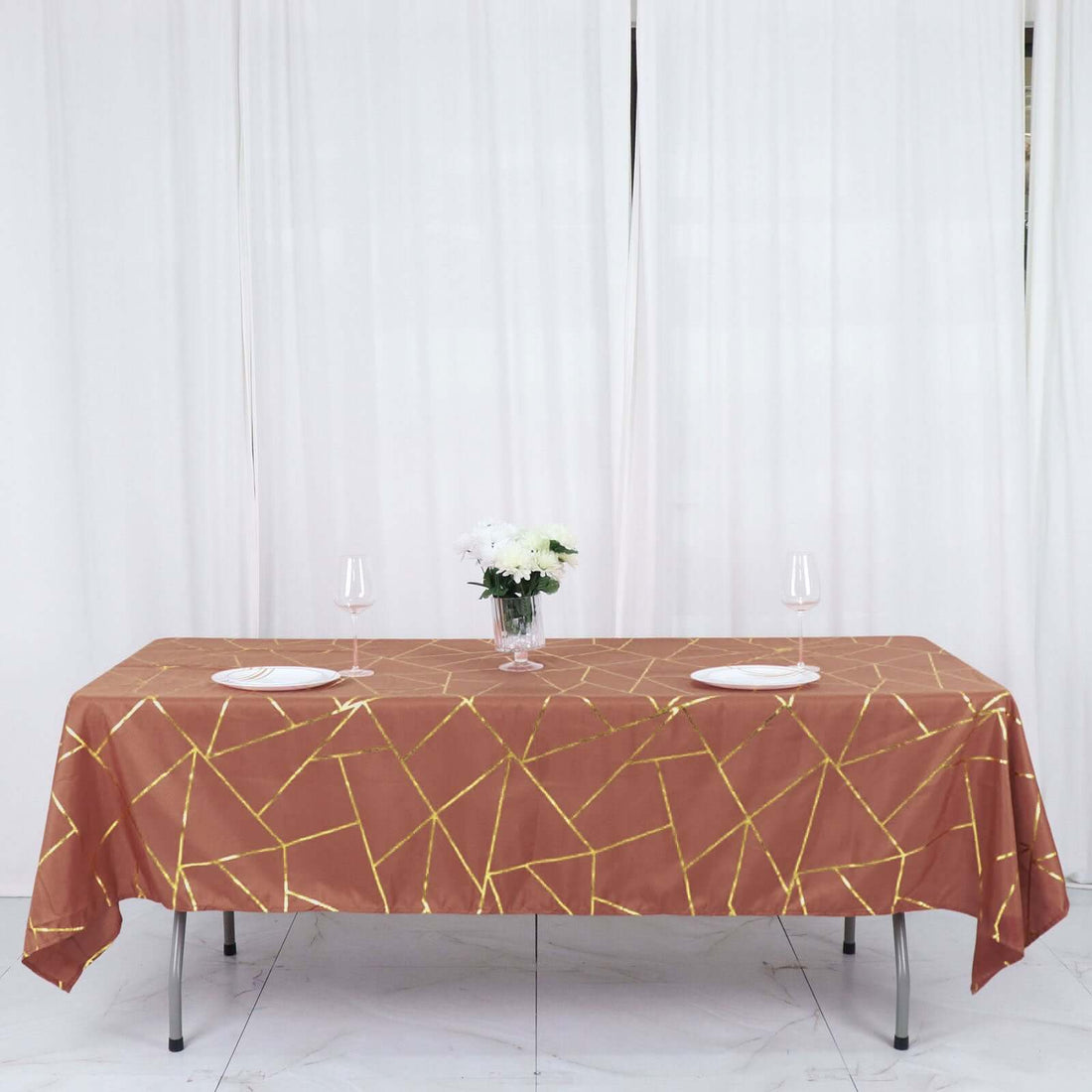 Elegant brown tablecloth with gold geometric pattern on a dining table.