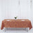 Elegant brown tablecloth with gold geometric pattern on a dining table.