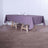 Elegant purple tablecloth on a wooden table with dining setup.