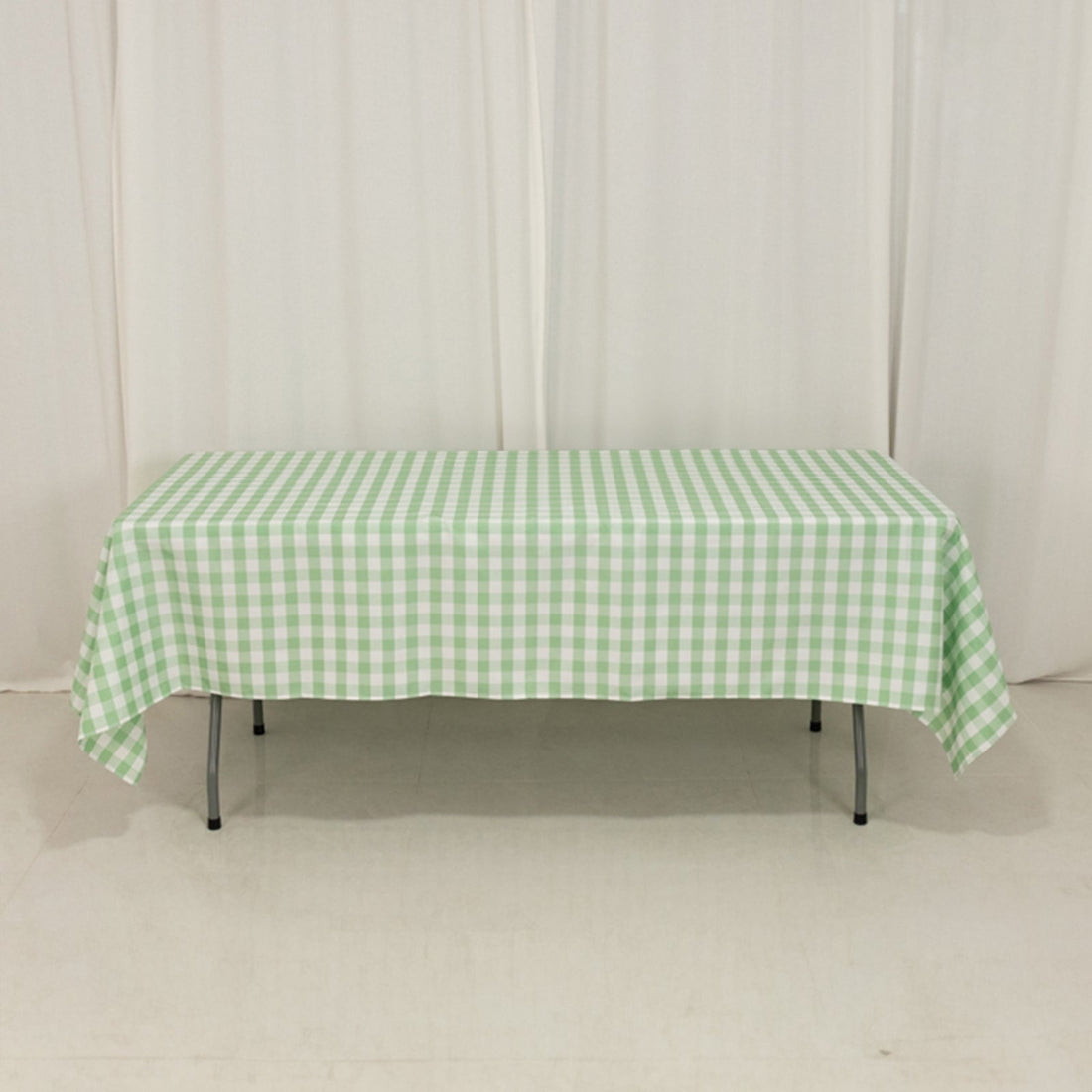 Green and white checked tablecloth on a plain table
