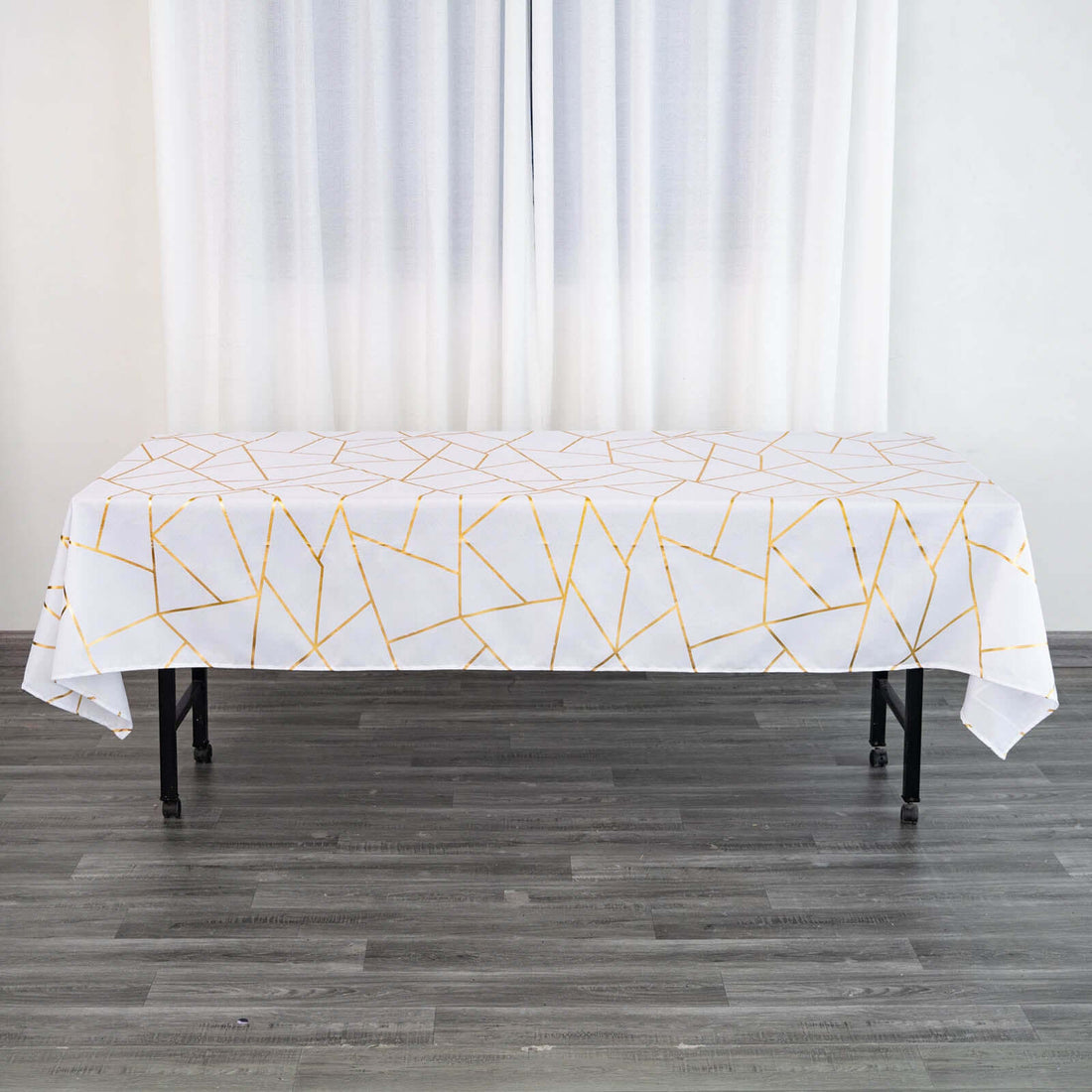 Geometric gold and white tablecloth on a dining table.