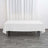 White tablecloth draped over a table in a minimalistic setting.
