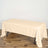 Beige tablecloth draped over a table on a wooden floor.