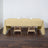 Beige tablecloth on a wooden table with glasses and napkins.