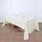 Elegant cream tablecloth draped over a wooden table with dining setup