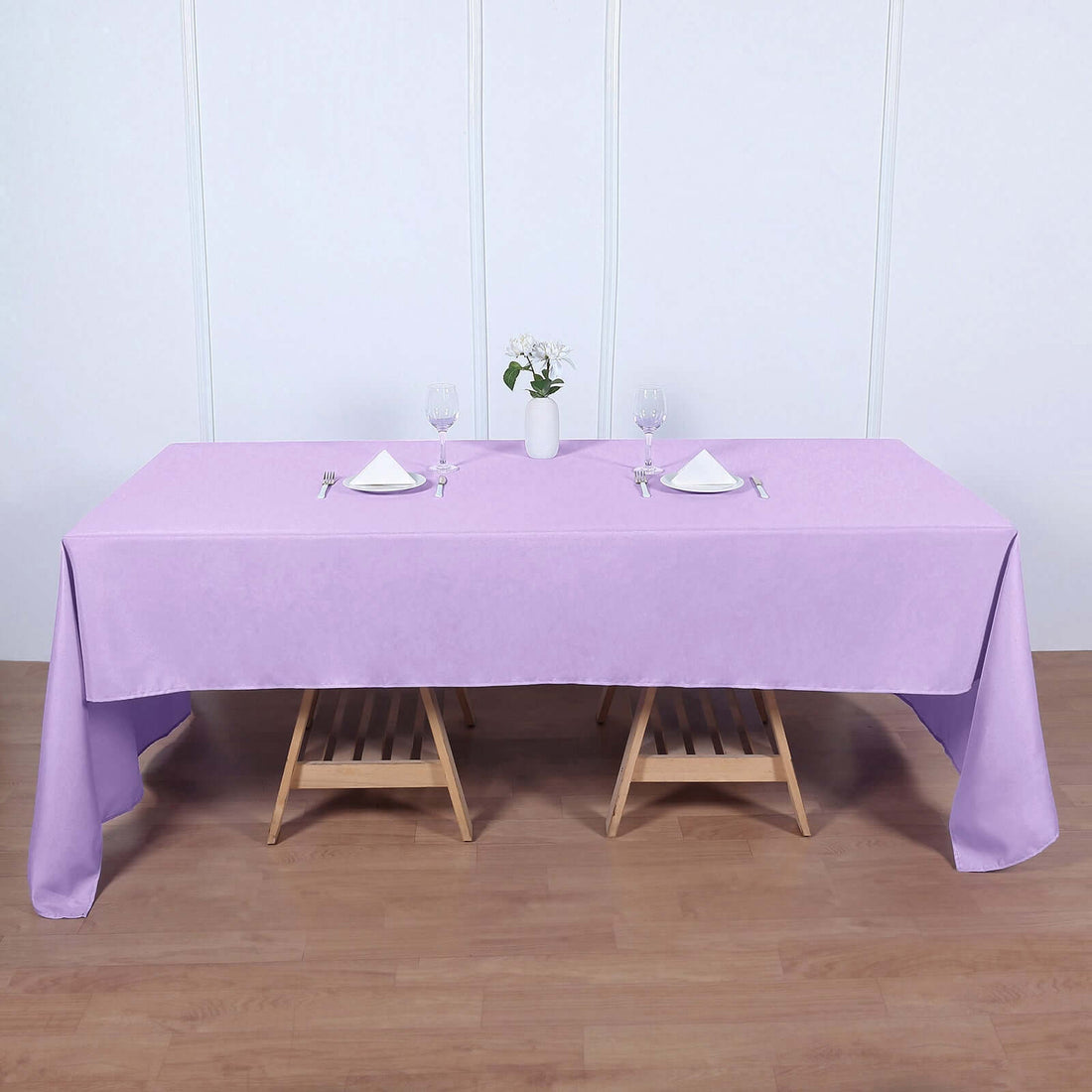 Lavender tablecloth on a wooden table set for dining