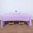 Lavender tablecloth on a wooden table set for dining