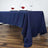 Navy blue tablecloth draped elegantly on a dining table with decorative napkins and glasses.